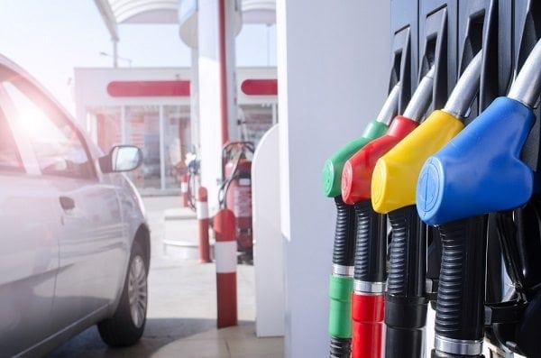 Four, colourful fuel pumps at a service station